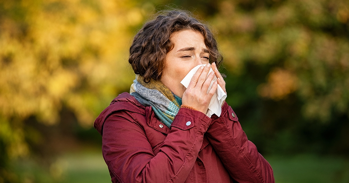 Woman treating seasonal allergies with tissue