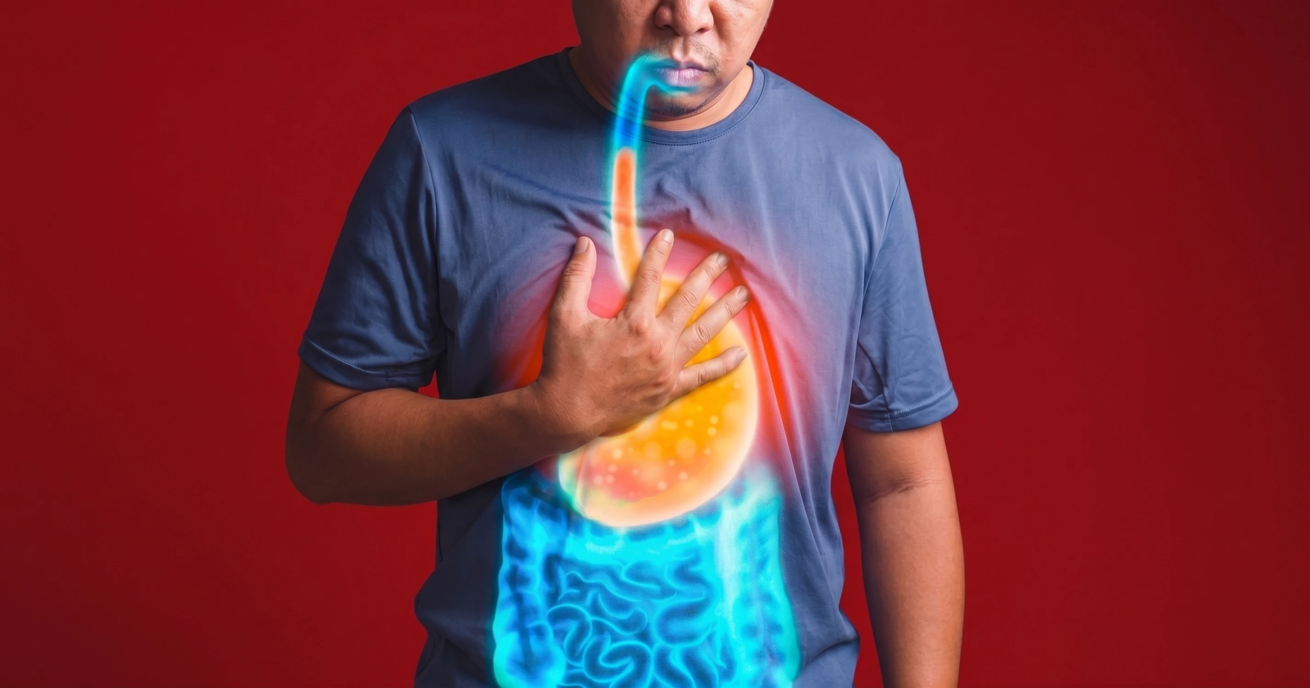 Man experiencing heartburn, shown with a glowing digital stomach overlay.