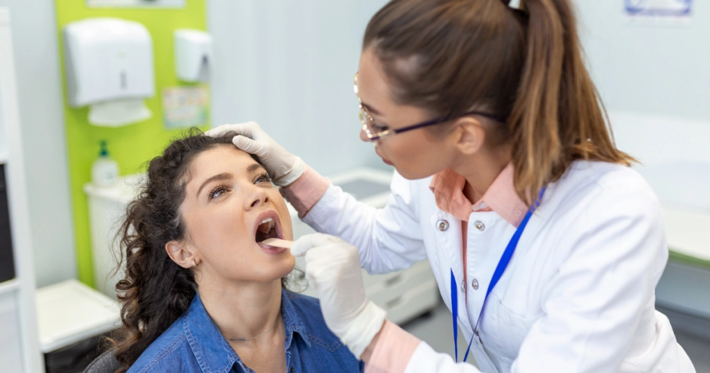 Doctor examining patient's throat for mucus